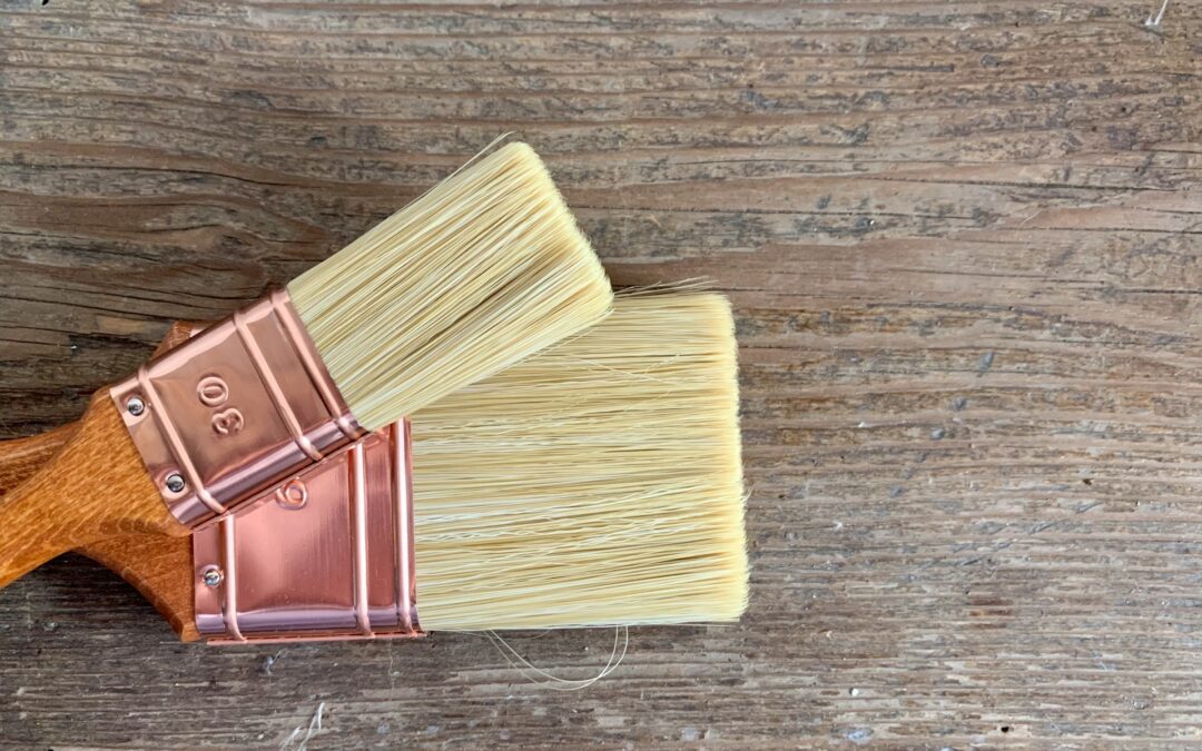 Two paintbrushes on table.